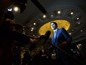 Prime Minister Justin Trudeau stops to speak to media as he arrives to the India Canada Business Session in New Delhi, India on Thursday, Feb. 22, 2018.