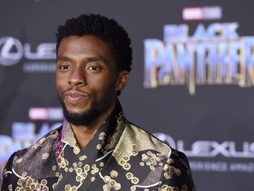FILE - In this Jan. 29, 2018 file photo, Chadwick Boseman, a cast member in "Black Panther," poses at the premiere of the film at The Dolby Theatre in Los Angeles. The language of Wakanda in "Black Panther" is very much real, including the "click" sounds that are making audiences murmur, impressed. That's thanks to South African actor and cast member John Kani, who introduced the idea of using it with his onscreen son, Chadwick Boseman.