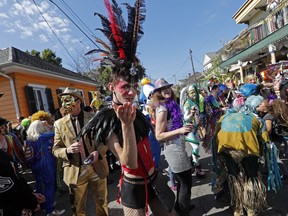 A reveler blows a kiss to the camera during the Society de Sainte Anne parade, on Mardi Gras day in New Orleans, Tuesday, Feb. 13, 2018.
