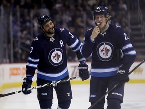 Jets sniper Patrik Laine (right) borrows from Alex Ovechkin's style: keep it simple and shoot as much as you can. (The Canadian Press)
