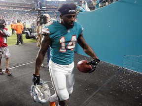 Miami Dolphins wide receiver Jarvis Landry (14) leaves the field after being ejected from the game for unsportsmanlike conduct during an NFL game against the Buffalo Bills, Sunday, Dec. 31, 2017, in Miami Gardens, Fla. (AP Photo/Wilfredo Lee)