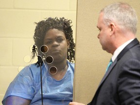 Latarsha Sanders, 43, is arraigned in Brockton, Mass., District Court on two counts of murder, on Tuesday, Feb. 6, 2018 with her defense attorney Joseph Krowski. Jr. (Marc Vasconcellos/The Enterprise via AP, Pool)