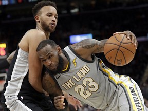 Cleveland Cavaliers' LeBron James (23) drives past San Antonio Spurs' Kyle Anderson Sunday, Feb. 25, 2018, in Cleveland. (AP Photo/Tony Dejak)
