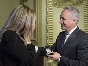 Arthabaska Coalition Avenir Quebec MNA Eric Lefebvre presents a ring to his life partner Genevieve Laliberte after asking her to marry him, Wednesday, February 14, 2018 at the legislature in Quebec City.