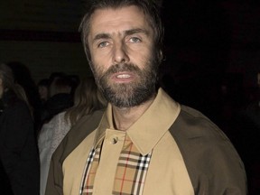 Liam Gallagher poses for photographers before the Burberry Autumn/Winter 2018 fashion week runway show in London, Saturday, Feb. 17, 2018.