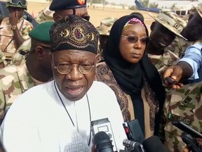 In this image taken from video, Lai Muhammed, Nigerian Minister of Information, speaks to the media in Dapchi, Yobe State, Nigeria, on Thursday Feb. 22, 2018. Parents in northern Nigeria say more than 100 girls are still missing three days after suspected Boko Haram extremists attacked their school. The announcement comes after government officials in Yobe state acknowledged that some 50 young women remained unaccounted for in the Monday evening attack. (AP Photo)