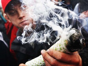 Marijuana supporters smoke on Parliament Hill during 420 celebrations in Ottawa, April 20, 2011. (Chris Roussakis/Postmedia)