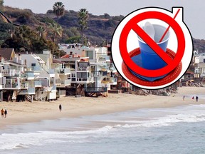 In this Dec. 20, 2015, file photo, waves roll up to and under homes perched over a sandy beach in Malibu, Calif.