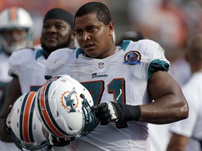 In this Dec. 16, 2012 file photo, Miami Dolphins tackle Jonathan Martin (71) watches from the sidelines during a game against the Jacksonville Jaguars, in Miami. (AP Photo/Wilfredo Lee, File)