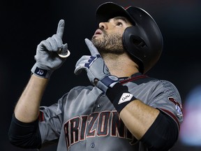 Arizona Diamondbacks' J.D. Martinez gestures after hitting an RBI single off Colorado Rockies starting pitcher Tyler Chatwood Saturday, Sept. 2, 2017, in Denver. (AP Photo/David Zalubowski)