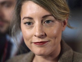 Minister of Canadian Heritage Melanie Joly speaks to reporters after leaving a cabinet meeting on Parliament Hill in Ottawa on Feb. 6, 2018.