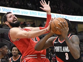 In this Jan. 1, 2018, file photo, Chicago Bulls forward Nikola Mirotic, left, defends against Portland Trail Blazers forward Al-Farouq Aminu (8) in Chicago. (AP Photo/David Banks, File)