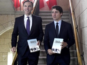 Minister of Finance Bill Morneau walks with Prime Minister Justin Trudeau, right, before tabling the budget in the House of Commons on Parliament Hill in Ottawa on Tuesday, Feb. 27, 2018.