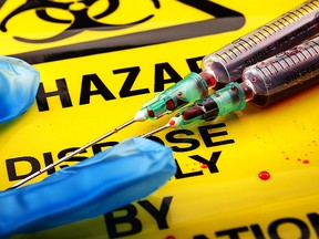 Biohazard logo, medical gloves and syringes