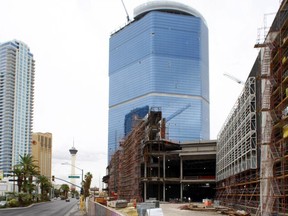 FILE - This Oct. 12, 2009 file photo shows the stalled Fontainebleau Las Vegas casino-hotel project in Las Vegas. The hulking, bluish casino-resort, which has sat unfinished on the Las Vegas Strip since 2009 and became a poster child of the Great Recession, is now scheduled to open in late 2020 under a partnership between hospitality giant Marriott International and New York-based global real estate firm Witkoff. The new luxury property, which will feature a casino and approximately 4,000 rooms and suites, announced Monday, Feb. 12, 2018 it will also be home to the Strip's first JW Marriott. (Steve Marcus/Las Vegas Sun via AP, File) ORG XMIT: NVLVS501