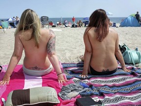 In this Aug. 26, 2017, file photo women go topless as they participate in the Free the Nipple global movement during Go Topless Day at Hampton Beach, N.H. (Ioanna Raptis/Portsmouth Herald via AP, File)