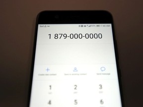 The area code 879 is shown on a cell phone.