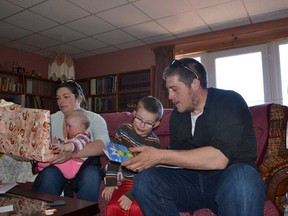 Richard Kirk, 33, rescued two people from an overturned car in a ditch filled with icy water near Kentville on Feb. 2. He's pictured here in a recent family handout photo with son Connor Kirk, second from right, wife Amelia Kirk and daughter Abigail Kirk at his home in Hall's Harbour, N.S.
