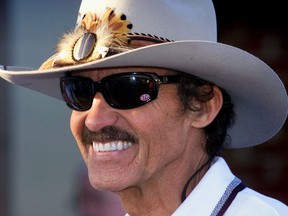 In this Oct. 6, 1999 file photo, seven-time Winston Cup champion Richard Petty smiles as he talks in the garage area at the Lowe's Motor Speedway in Concord, N.C.