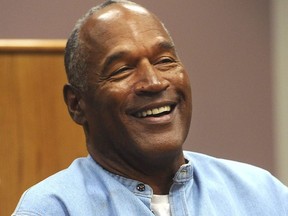 Former NFL football star O.J. Simpson laughs as he appears via video for his parole hearing at the Lovelock Correctional Center in Lovelock, Nev., on Thursday, July 20, 2017.  Simpson was granted parole Thursday after more than eight years in prison for a Las Vegas hotel heist, successfully making his case in a nationally televised hearing that reflected America's enduring fascination with the former football star.  (Jason Bean/The Reno Gazette-Journal via AP, Pool) ORG XMIT: NVREN419