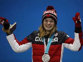 Silver medalist in the women's 1000 meters short track speedskating, Kim Boutin, of Canada, smiles during the medals ceremony at the 2018 Winter Olympics in Pyeongchang, South Korea, Friday, Feb. 23, 2018. Kim Boutin will be Canada's flag bearer at the closing ceremony of the Pyeongchang Olympics.