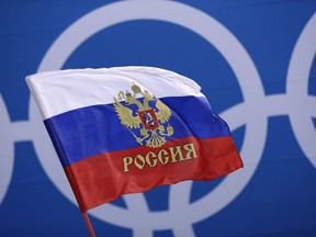 A Russian supporter waves a flag before the preliminary round of the men's hockey game between the team from Russia and the United States at the 2018 Winter Olympics in Gangneung, South Korea, Saturday, Feb. 17, 2018. (AP Photo/Matt Slocum)