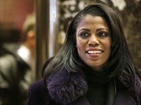 In this Dec. 13, 2016 file photo, Omarosa Manigault smiles at reporters as she walks through the lobby of Trump Tower in New York.  (AP Photo/Seth Wenig)