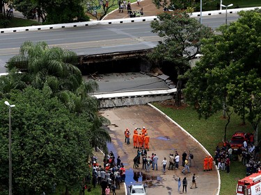 Emergency personnel work on an overpass that collapsed in the centre of Brasilia, Brazil, Tuesday, Feb. 6, 2018. (AP Photo/Eraldo Peres)