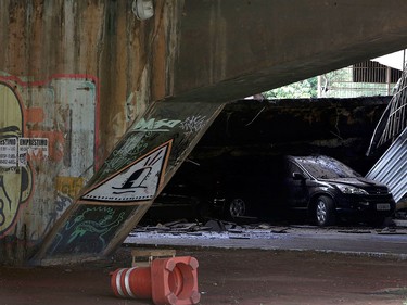 A damaged car lies underneath a collapsed overpass in Brasilia, Brazil, Tuesday, Feb. 6, 2018.  (AP Photo/Eraldo Peres)
