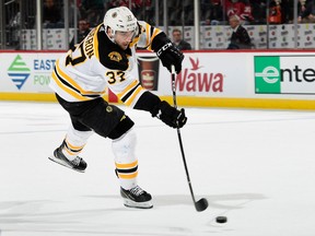 Patrice Bergeron of the Boston Bruins scores a goal against the New Jersey Devils at Prudential Center on Feb. 11, 2018