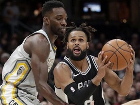 San Antonio Spurs' Patty Mills, right, drives past Cleveland Cavaliers' Jeff Green Sunday, Feb. 25, 2018, in Cleveland. (AP Photo/Tony Dejak)