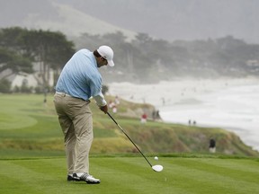 Dallas Cowboys quarterback Tony Romo hits from the 10th tee of the Pebble Beach Golf Links during the AT&T Pebble Beach National Pro-Am golf tournament in Pebble Beach, Calif.