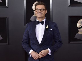 Ryan Seacrest arrives at the 60th annual Grammy Awards at Madison Square Garden in New York on Jan. 28, 2018. The E! channel says an investigation into a misconduct allegation against Seacrest found insufficient evidence to support the claims.