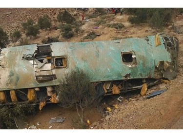 In this photo provided by the government news agency Andina, a crashed bus lays on the bottom of a cliff in Arequipa, Peru, Wednesday, Feb. 21, 2018.