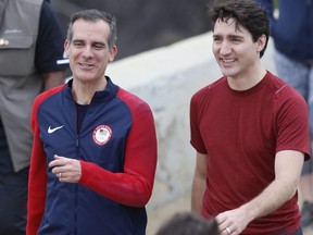 Canadian Prime Minister Justin Trudeau, right, with Los Angeles Mayor Eric Garcetti smiles after a hike in the hills surrounding the Griffith Observatory Saturday, Feb. 10, 2018. (AP Photo/Damian Dovarganes)