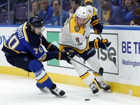 Centre Kyle Turris, right, seen here trying to protect the puck from the Blues' Oskar Sundqvist, signed a six-year contract extension with the Predators immediately after the trade from the Senators.