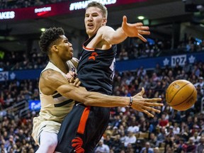 Raptors’ Jakob Poeltl (right) tries to block a pass attempt from Bucks star Giannis Antetokounmpo at the ACC on Friday. (Ernest Doroszuk/Postmedia Network)