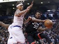 Toronto Raptors guard Delon Wright (55) passes around New York Knicks forward Johnny O'Bryant III at the Air Canada Centre in Toronto on Thursday February 8, 2018. (Stan Behal/Toronto Sun)