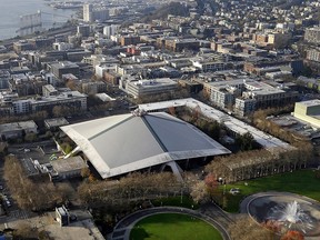The iconic sloped roof of KeyArena, a sports and entertainment venue at the Seattle Center, is seen from above Monday, Dec. 4, 2017, in Seattle. (AP Photo/Elaine Thompson)