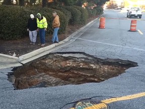 A screengrab of a video from The Augusta Chronicle shows a  sinkhole outside the Augusta Exchange mall. (Video Screenshot)