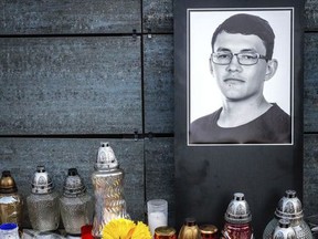 Candles and flowers lay by the entrance to offices of news website Aktuality.sk, the employer of the murdered investigative journalist Jan Kuciak, in Bratislava, Slovakia, Tuesday, Feb. 27, 2018. Slovakia's top police officer Tibor Gaspar said the investigative reporter has been shot dead in his home in Velka Maca together with his girlfriend Martina Kusnirova.