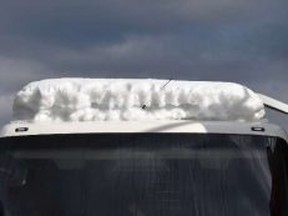 Swiss police say they’ve stopped a Swedish bus that was travelling along a highway with more than 1.6 tons of snow on its roof. (Polizei Kanton Solothurn photo)