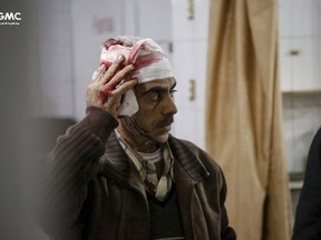 This photo released on Tuesday Feb. 20, 2018 provided by the Syrian anti-government activist group Ghouta Media Center, which has been authenticated based on its contents and other AP reporting, shows an injured Syrian man who was wounded by the shelling of the Syrian government forces, waits to receive treatment at a makeshift hospital, in Ghouta, suburb of Damascus, Syria.
