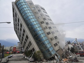 A residential building leans on a collapsed first floor following an earthquake, in Hualien, southern Taiwan, on Feb. 7, 2018.