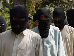 Alleged fighters for the Islamic State and Taliban walk being presented to the media at the police headquarters in Jalalabad on October 3, 2017.
Afghan police said 10 alleged Islamic state fighters, including two non-Afghans, and four Taliban militants were arrested during an operation in Nangarhar province. / AFP PHOTO / NOORULLAH SHIRZADA        (Photo credit should read NOORULLAH SHIRZADA/AFP/Getty Images)