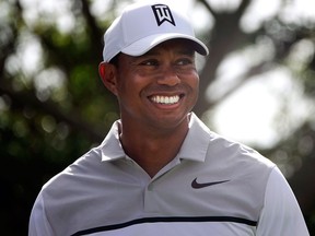 Tiger Woods smiles as he jokes with his playing partners during the Pro-Am for the Honda Classic golf tournament, on Feb. 21, 2018