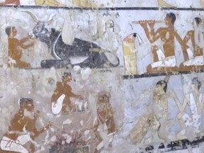 This image taken from video on Saturday, Feb. 3, 2018, shows wall paintings inside a 4,400-year-old tomb near the pyramids outside Cairo, Egypt. Egypt's Antiquities Ministry announced the discovery Saturday and said the tomb likely belonged to a high-ranking official known as Hetpet during the 5th Dynasty of ancient Egypt. The tomb includes wall paintings depicting Hetpet observing different hunting and fishing scenes. (AP Photo/APTN)