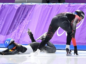 Japan's Ayano Sato (left) and Canada's Ivanie Blondin fall in the women's mass start semifinal at the Pyeongchang Olympics on Feb. 24.