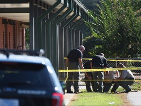 Members of law enforcement investigate an area at Townville Elementary School on Sept. 28, 2016, in Townville, S.C.