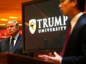 In this Monday May 23, 2005 file photo Donald Trump, left, listens as Michael Sexton introduces him to announce the establishment of Trump University at a press conference in New York.
